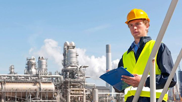 Man wearing hardhat with clipboard