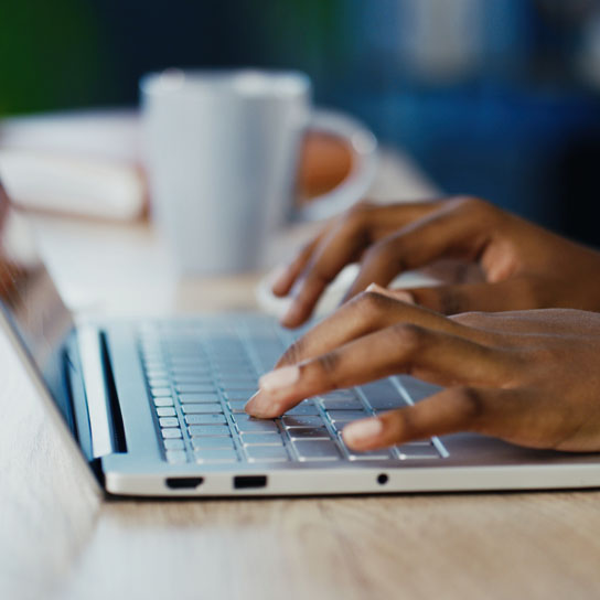 Person typing on laptop